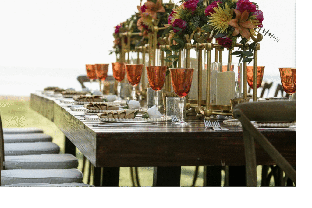 Banquet table with place settings, stemware and floral centerpieces